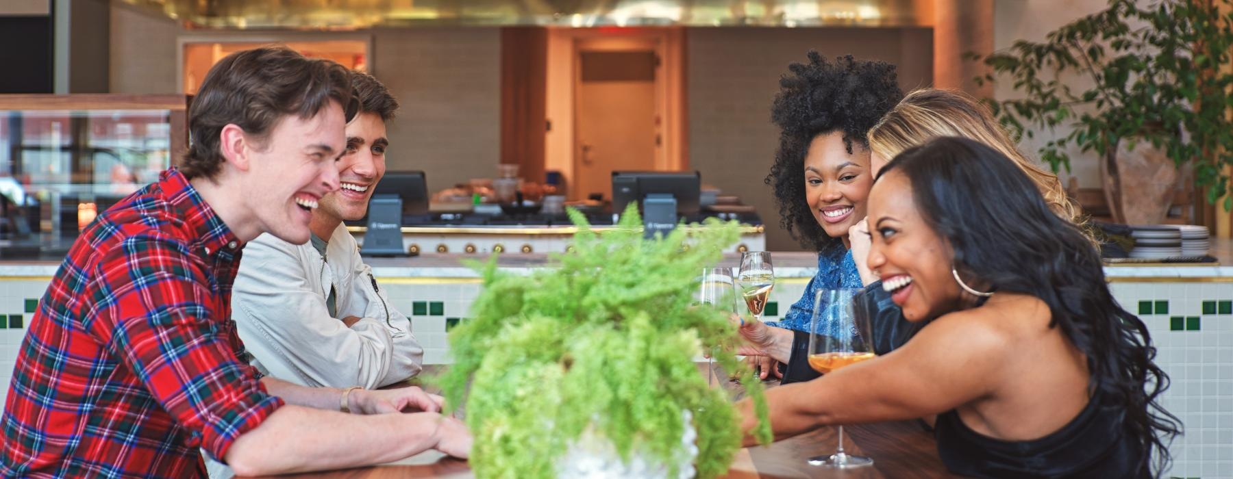 a group of people sitting at a restaurant table with drinks